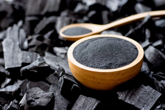 Charcoal is crushed and put into a large cup of charcoal.